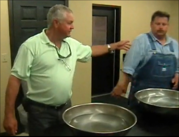 Farmers demonstrate how to clean up oil with hay. Farmers demonstrate how to clean up oil with hay.